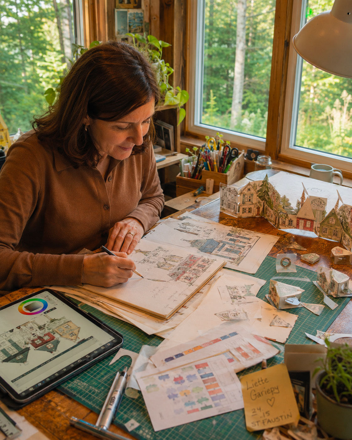 Canadian artist Liette Gariépy creating the original illustrations behind CranberryLand Christmas village houses, shops and characters.